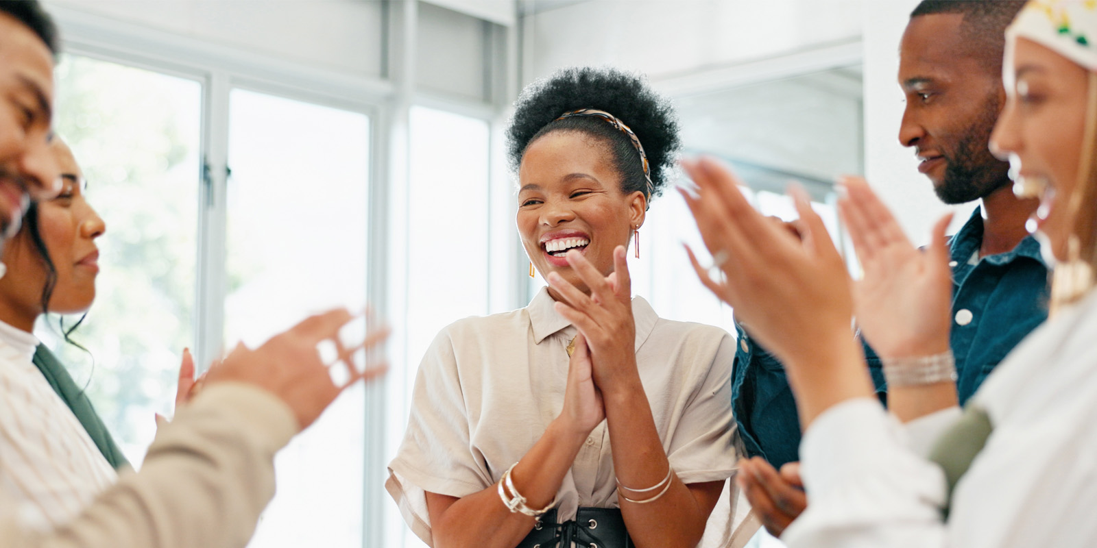 Group of people talking laughing and clapping hands
