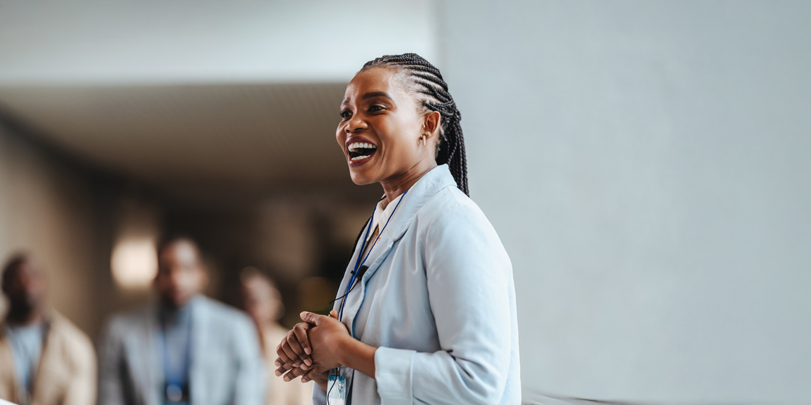 Black woman at front of room speaking to group